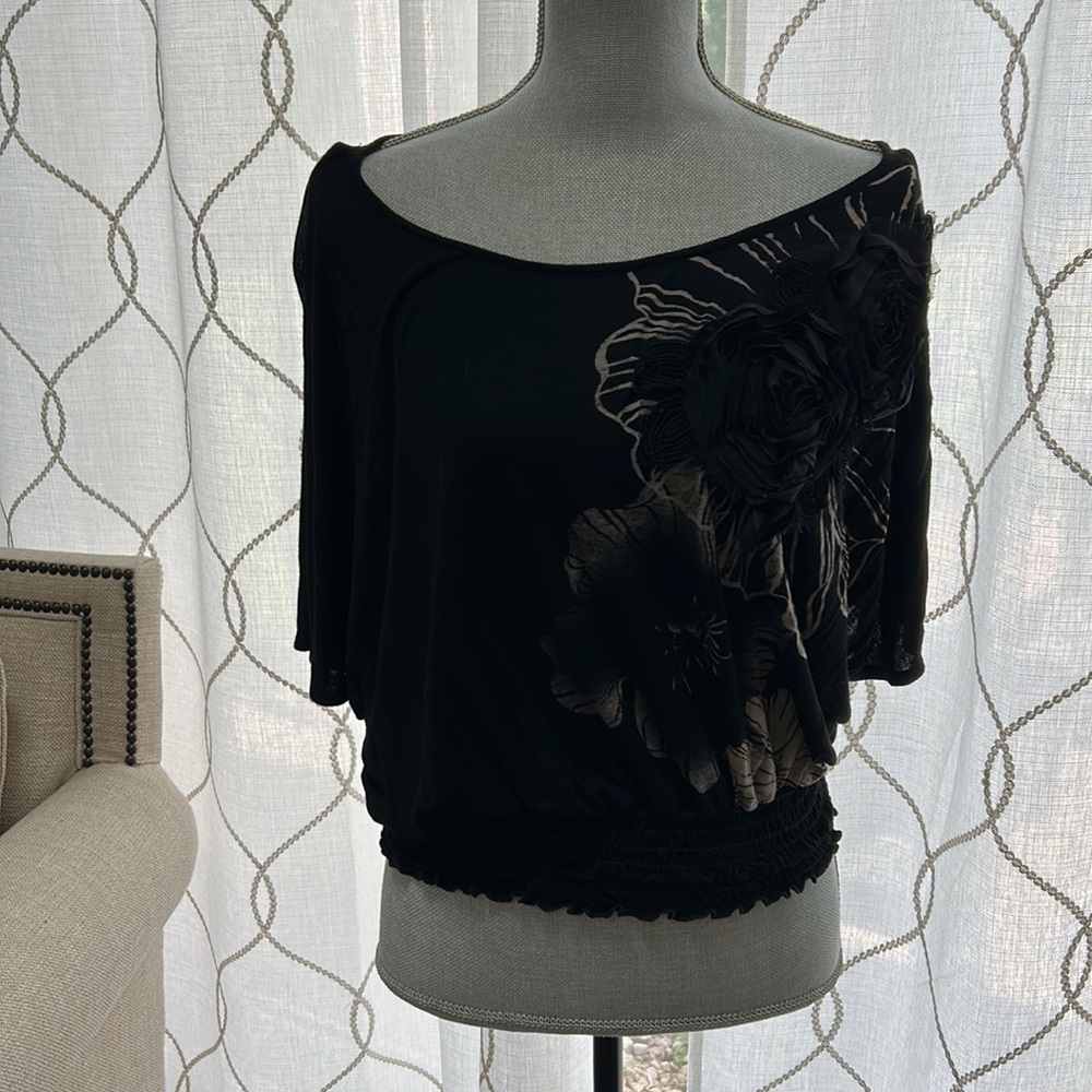 Loose black top with gold accents